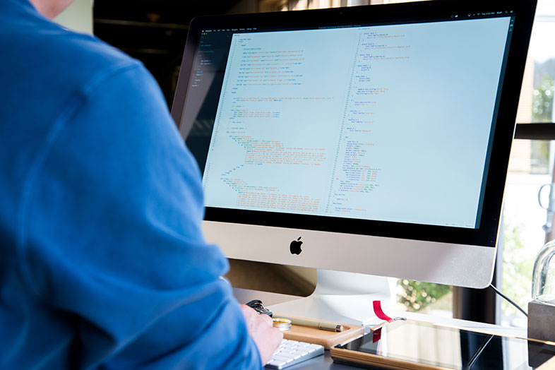 developer coding on mac computer